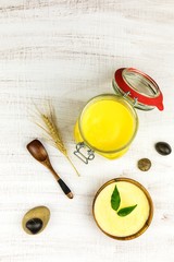 Ghee or clarified butter in jar. Healthy eating and using organic fresh made products. Healthy ingredient for cooking organic meal.Spoon with ghee butter