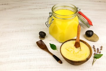 Ghee or clarified butter in jar. Healthy eating and using organic fresh made products. Healthy ingredient for cooking organic meal.Spoon with ghee butter