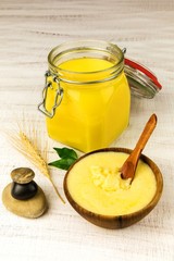 Ghee or clarified butter in jar. Healthy eating and using organic fresh made products. Healthy ingredient for cooking organic meal.Spoon with ghee butter