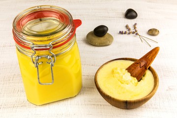 Ghee or clarified butter in jar. Healthy eating and using organic fresh made products. Healthy ingredient for cooking organic meal.Spoon with ghee butter