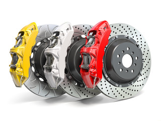 Braking system. Car brake disks with different perforations and calipers  isolated on white background.