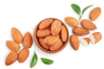 Almonds nuts with leaves in wooden bowl isolated on white background with clipping path and full...