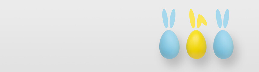 Blue and yellow easter eggs on a gradient gray background.