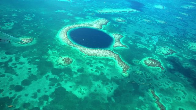 4k aerial view of the blue hole coral reef in belize