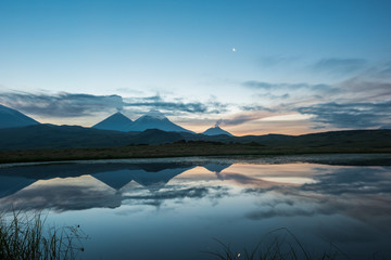 Fototapeta na wymiar Tolbachik volcano reflection in the quiet mountain lake, Kamchatka