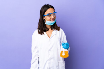 Scientist woman investigating a vaccine to cure coronavirus disease having doubts while looking side