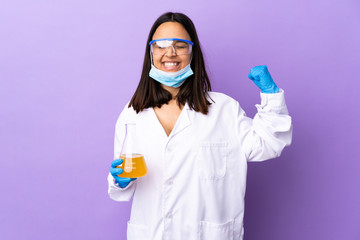 Scientist woman investigating a vaccine to cure coronavirus disease doing strong gesture