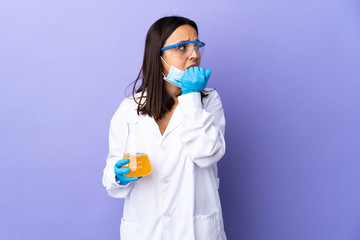 Scientist woman investigating a vaccine to cure coronavirus disease nervous and scared putting hands to mouth