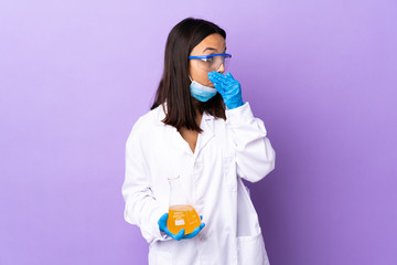 Scientist woman investigating a vaccine to cure coronavirus disease covering mouth and looking to the side