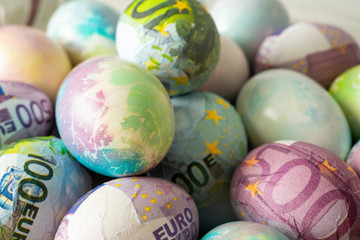Colorful eggs for Easter decorated with euro .
