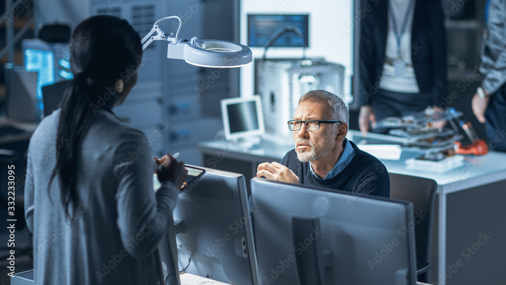 Poster shot of male industrial engineer talking with female manager about new efficient engine concept desi