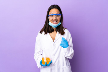 Scientist woman investigating a vaccine to cure coronavirus disease with surprise facial expression