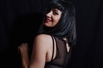 woman posing laughing on black background