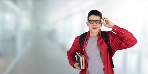 teenage student with glasses books and backpack at school