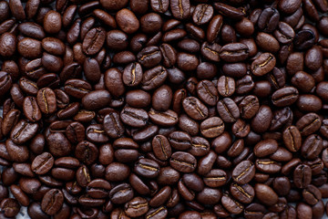 Top view dark roasted arabica coffee beans.