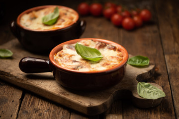 Lasagna dish on a rustic table. Food, mozzarella.