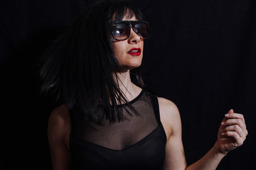 woman posing laughing with glasses on black background