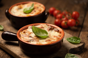 Lasagna dish on a rustic table. Food, mozzarella.