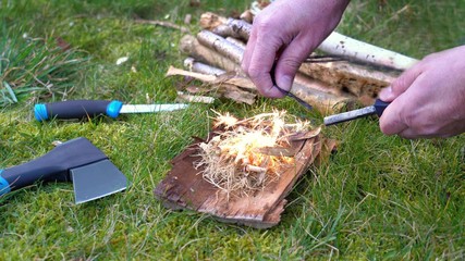 Burning campfire with flint in nature .