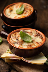Lasagna dish on a rustic table. Food, mozzarella.