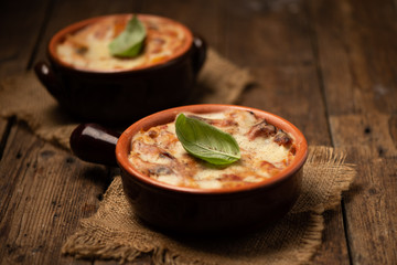 Lasagna dish on a rustic table. Food, mozzarella.
