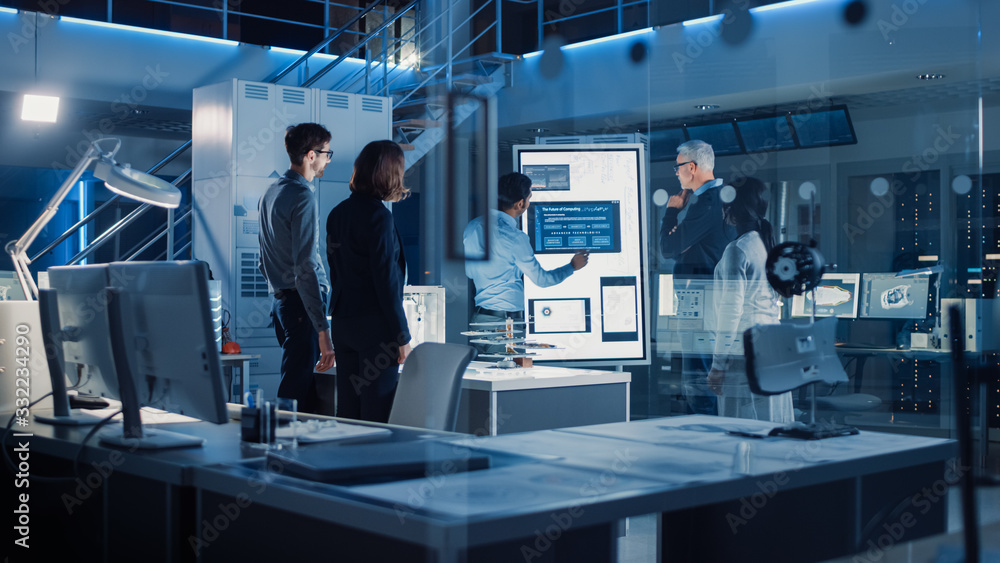 Leinwandbilder Engineers Meeting in Technology Research Laboratory: Engineers, Scientists and Developers Gathered Around Illuminated Conference Table, Talking and Finding Solution. Industrial Design Facility