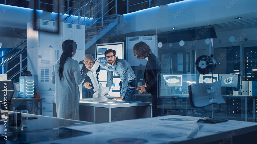 Poster Engineers Meeting in Robotic Research Laboratory: Engineers, Scientists and Developers Gathered Around Illuminated Conference Table, Talking, Using Tablet and Analysing Design of Industrial Robot Arm