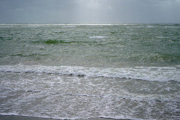 Waves lapping on a sandy beach shore