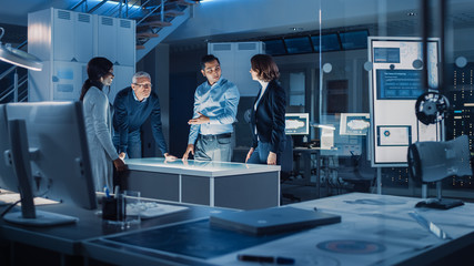 Engineers Meeting in Virtual Reality Content Design Studio: Engineers, Scientists and Game / Application Developers Gathered Around Illuminated Gesture Recognizing Conference Table.
