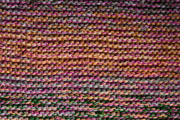 Fototapeta na wymiar Multicolored knitted texture in macro using shawl technique