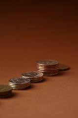 stacks of coins on a brown background with copy space vertical orientation