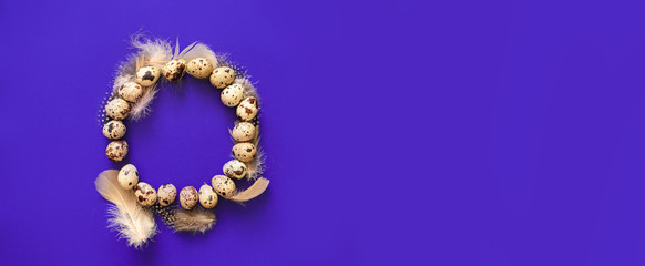 A circle of quail eggs and feathers on a bright purple background.