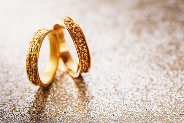 Two wedding rings on a brilliant background with a copy of space