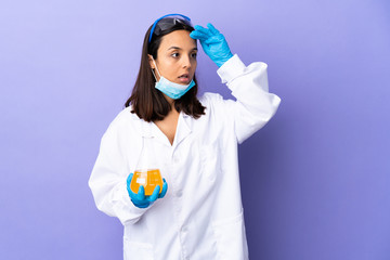 Scientist woman investigating a vaccine to cure coronavirus disease with surprise expression while looking side