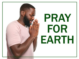 Praying African-American man on white background