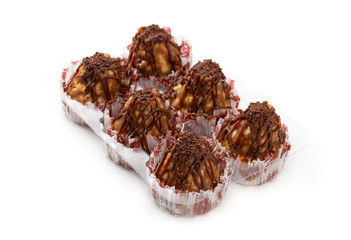 Cake anthill on a white background. Anthill cake in a plastic container from a supermarket.