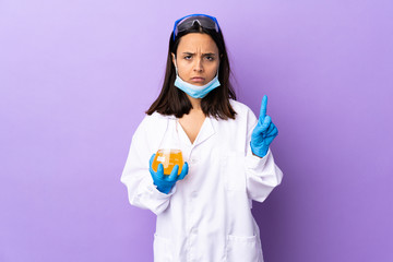 Scientist woman investigating a vaccine to cure coronavirus disease counting one with serious expression