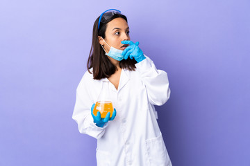 Scientist woman investigating a vaccine to cure coronavirus disease doing surprise gesture while...