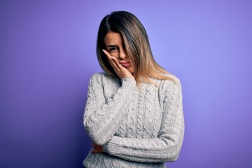 Young beautiful woman wearing casual sweater standing over isolated purple background thinking looking tired and bored with depression problems with crossed arms.