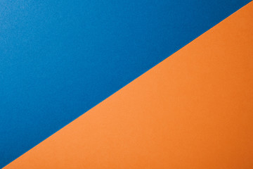 Blue and orange color paper background, texture, copy space, diagonal.