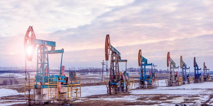 Working Oil Pump In Deserted District At Sunset