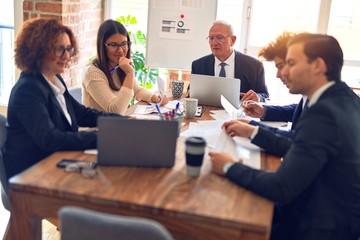 Group of business workers smiling happy and confident. Speaking with smile on face working together at the office.