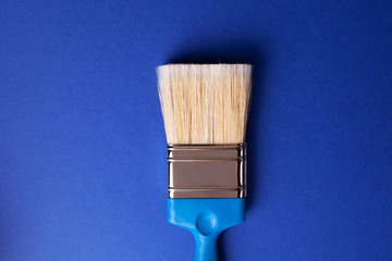 Paint brush on dark blue background.