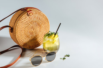 Bamboo bag with sunglasses and  lemonade. Summer Vacation concept.