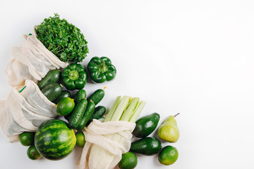 Organic vegetables and fresh green in reusable produce bags. Sustainable lifestyle. Plastic free concept. Flat lay, top view