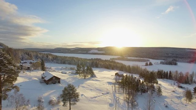 Cinematic aerial of a church and revealing a beautiful winter landscape during sunset 4K