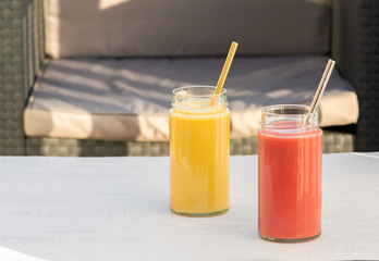 Yellow Banana, pear and red apple, raspberry smoothie. Glass, jar, metal straw. Restaurant, table, armchair. Health, vegetarian, vegan breakfast, drink. No plastic, Ecology. copy space. 