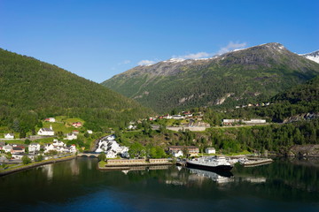 Fototapeta na wymiar Hellesylt is a small tourist village in Sunnmore region of Norway. Hellesylt lies at the Geirangerfjord.