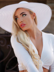 Beautiful model green eyes California casual crop top white hat cutoffs