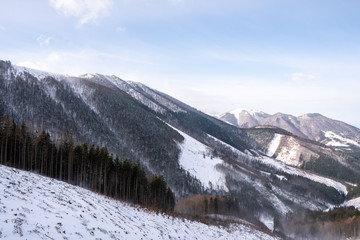 Fototapeta na wymiar Ridge of Mala Fatra snowy with mountain Krivan in background and valley below, Slovakia Mala Fatra